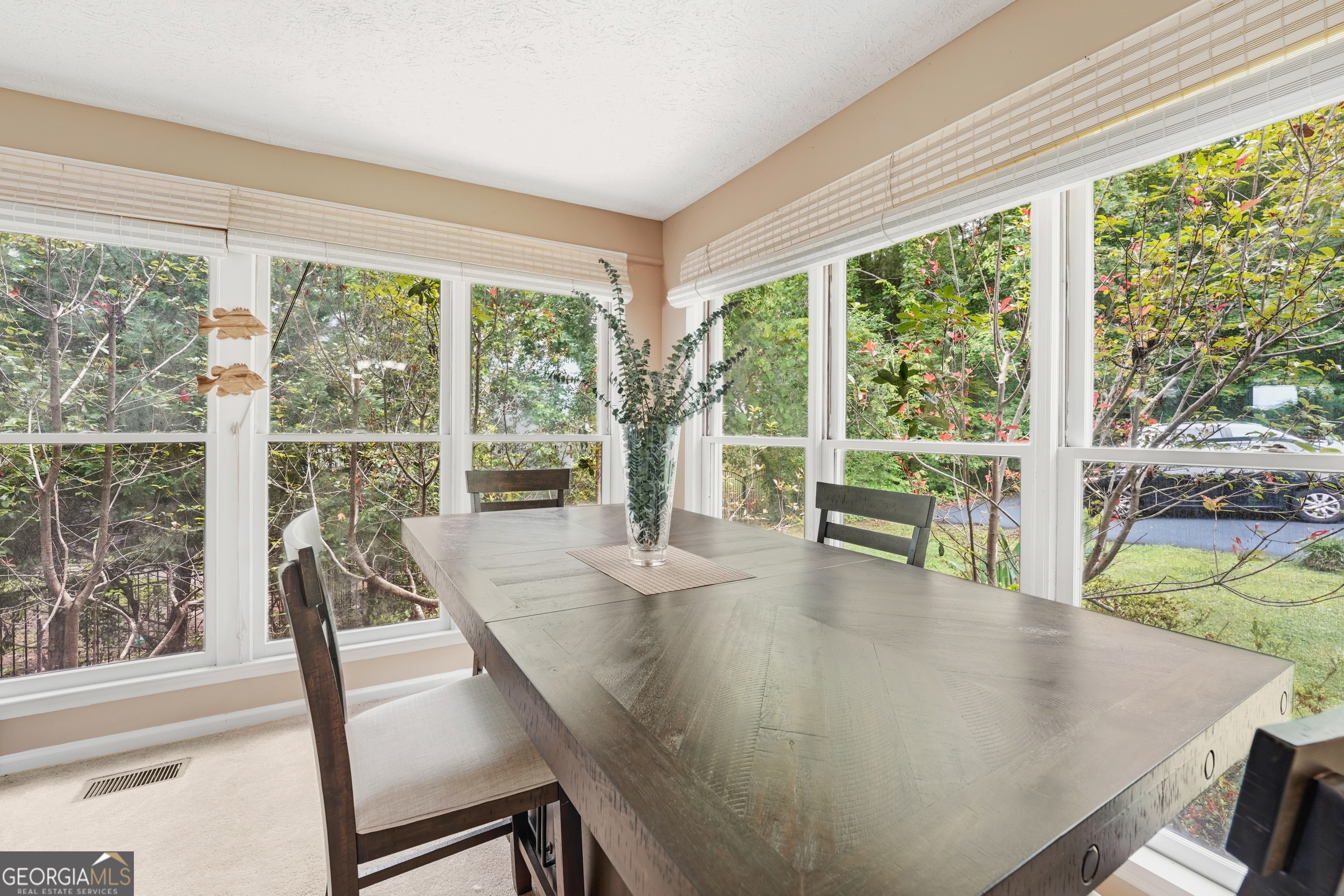 142 Tanglewood Road Southwest Eatonton, GA 31024 - Photo 16 of 50 a view of a dining room with furniture large windows and wooden floor