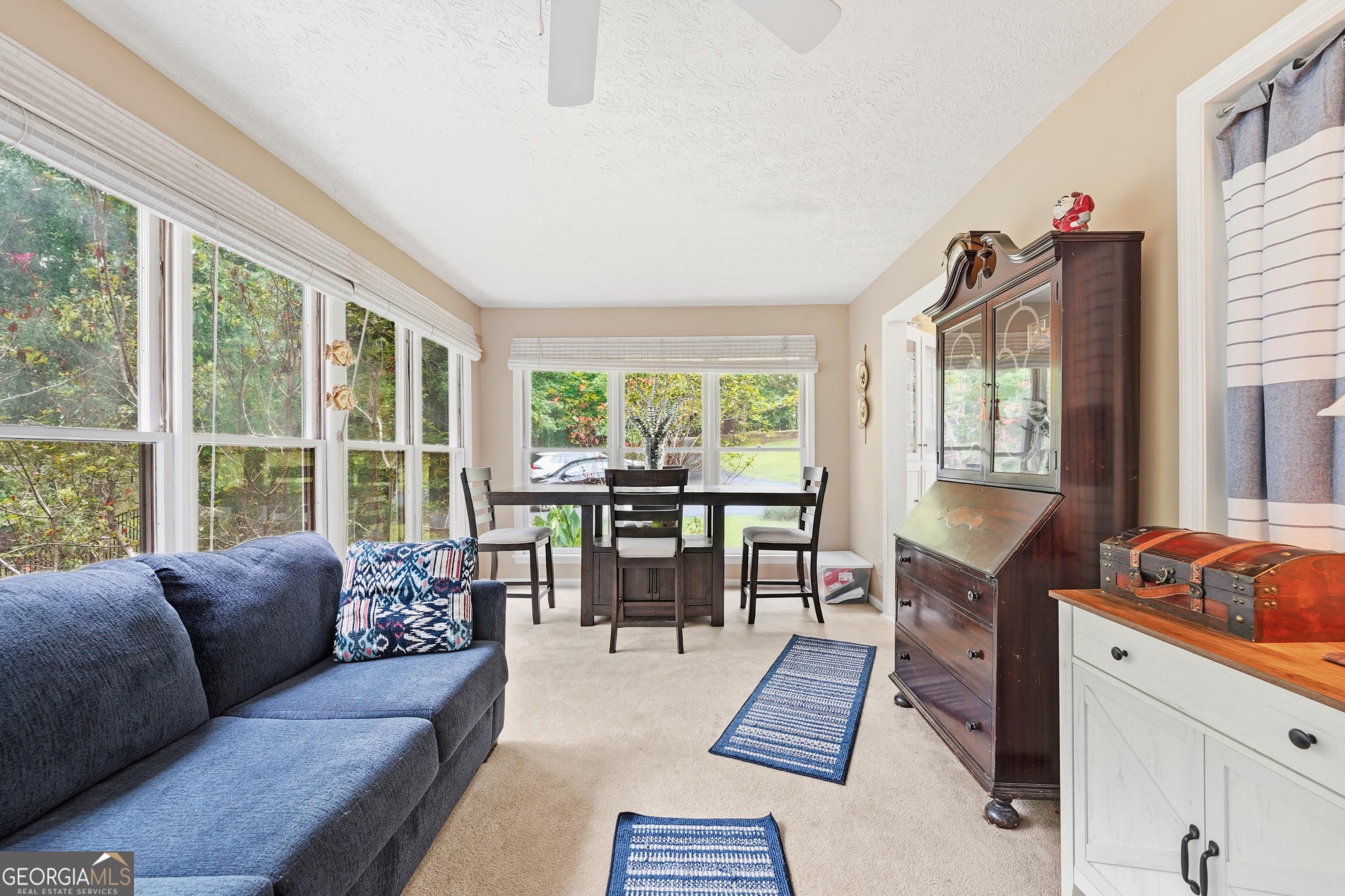 142 Tanglewood Road Southwest Eatonton, GA 31024 - Photo 18 of 50 a living room with furniture and a floor to ceiling window