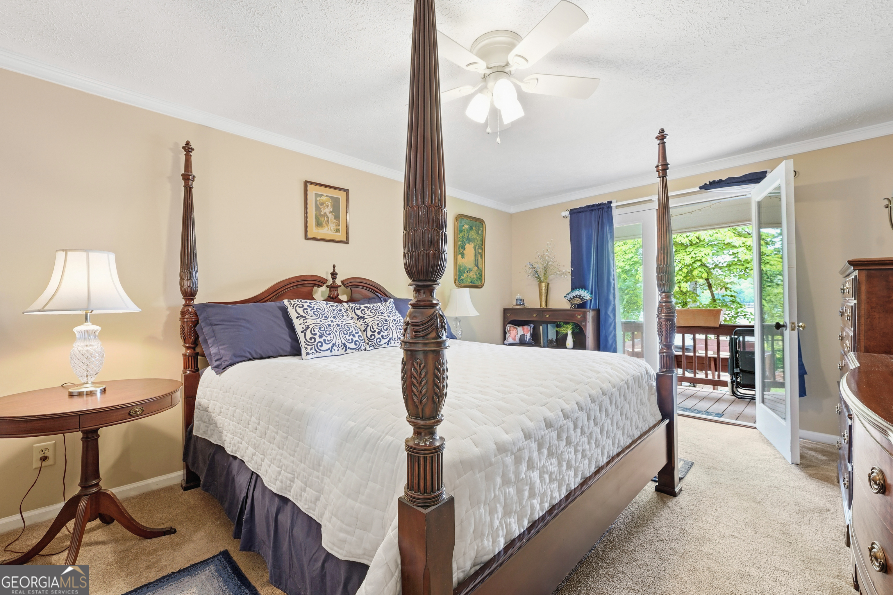 142 Tanglewood Road Southwest Eatonton, GA 31024 - Photo 21 of 50 a bedroom with a bed a table and windows