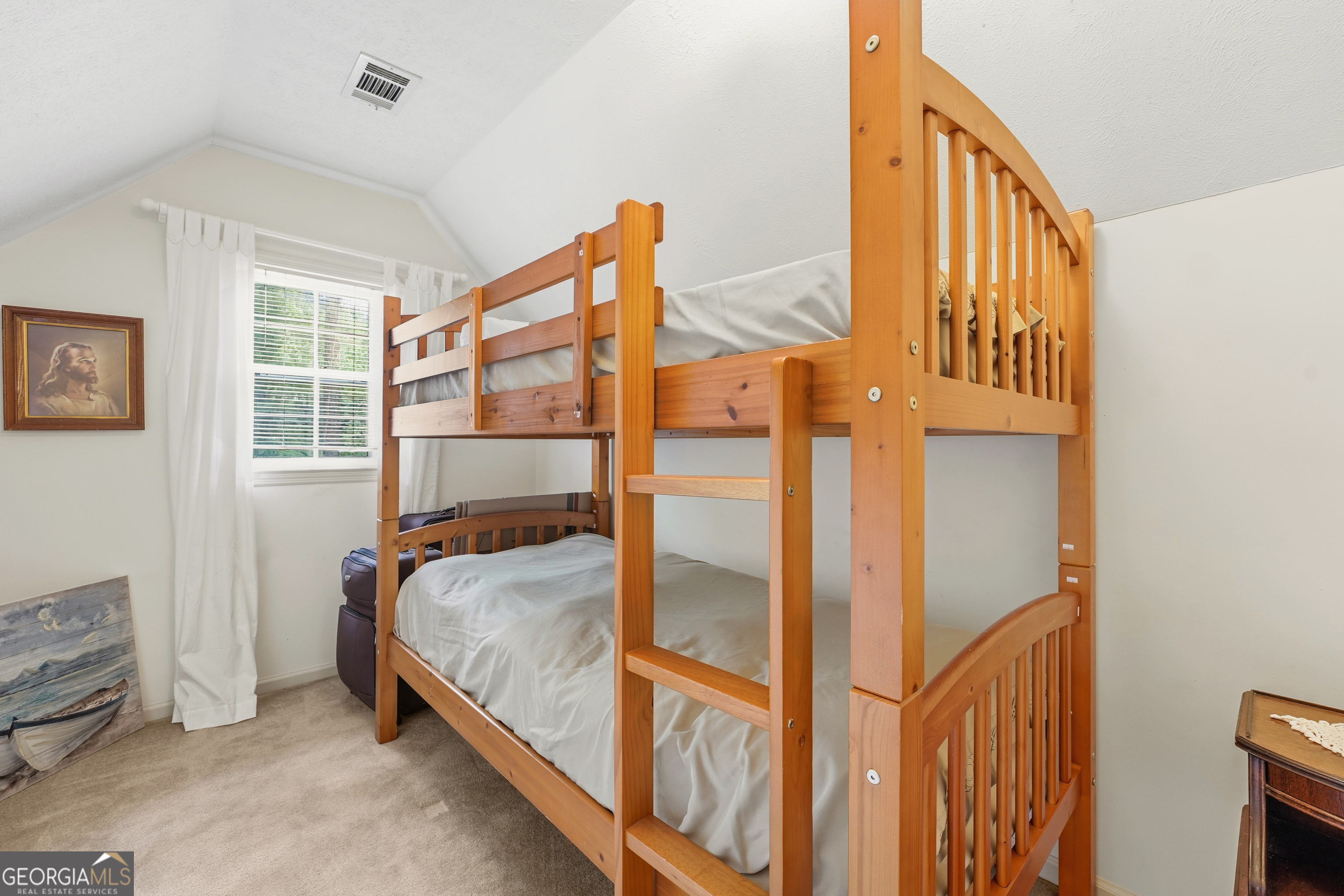 142 Tanglewood Road Southwest Eatonton, GA 31024 - Photo 24 of 50 a bed sitting in a bedroom next to a window