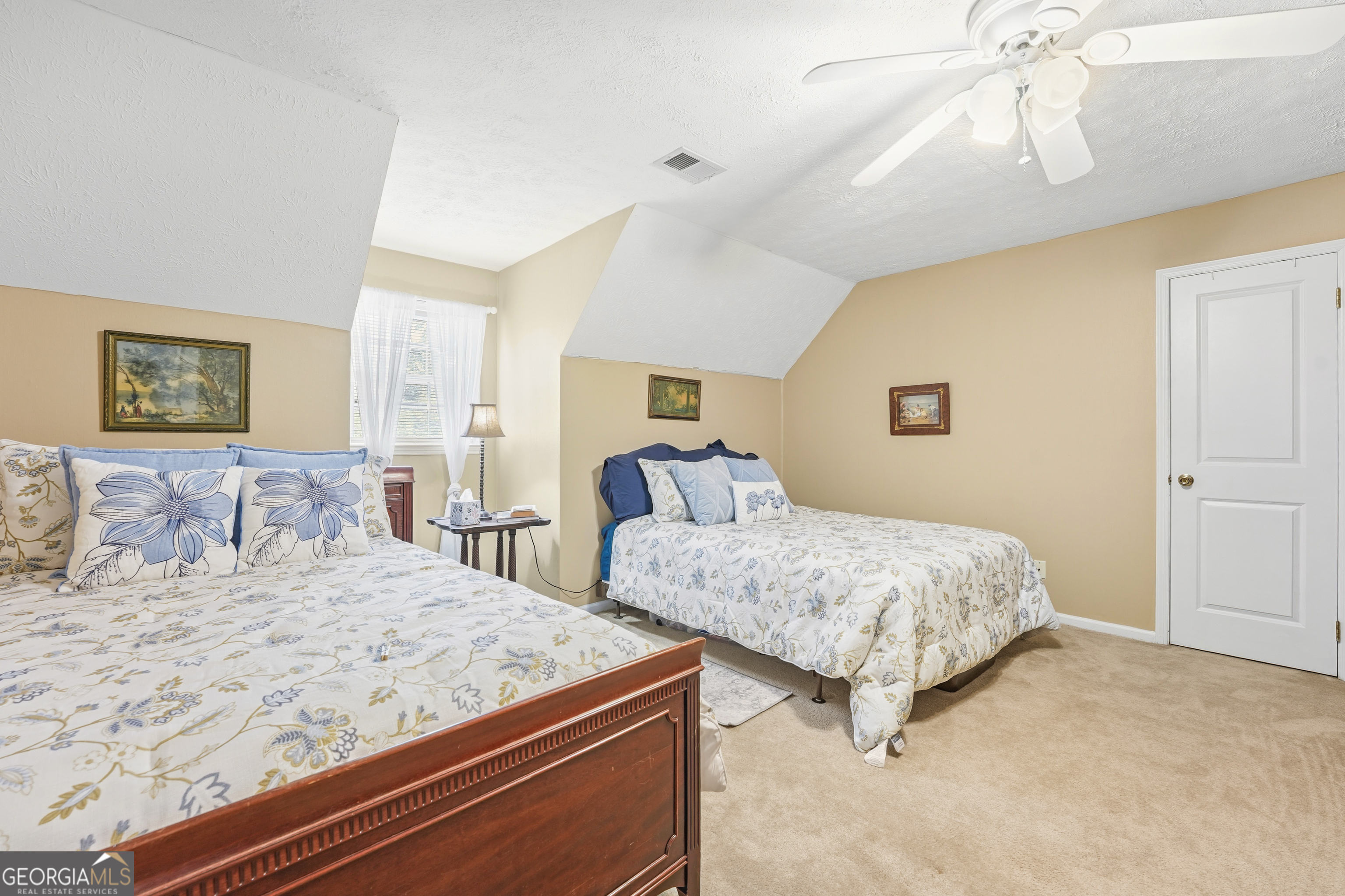 142 Tanglewood Road Southwest Eatonton, GA 31024 - Photo 26 of 50 a bedroom with two large bed and a chandelier