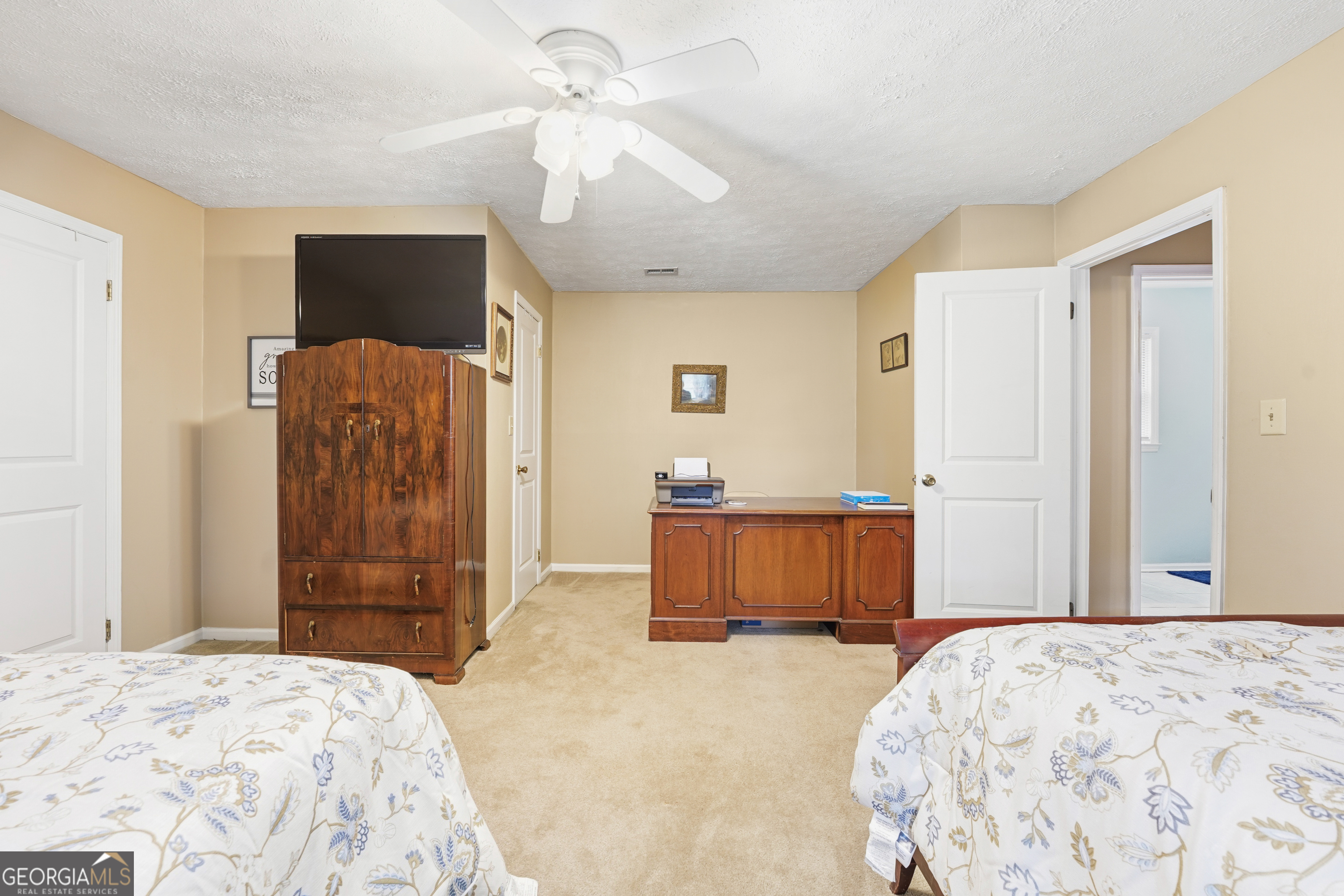 142 Tanglewood Road Southwest Eatonton, GA 31024 - Photo 27 of 50 a bedroom with a bed and a flat screen tv