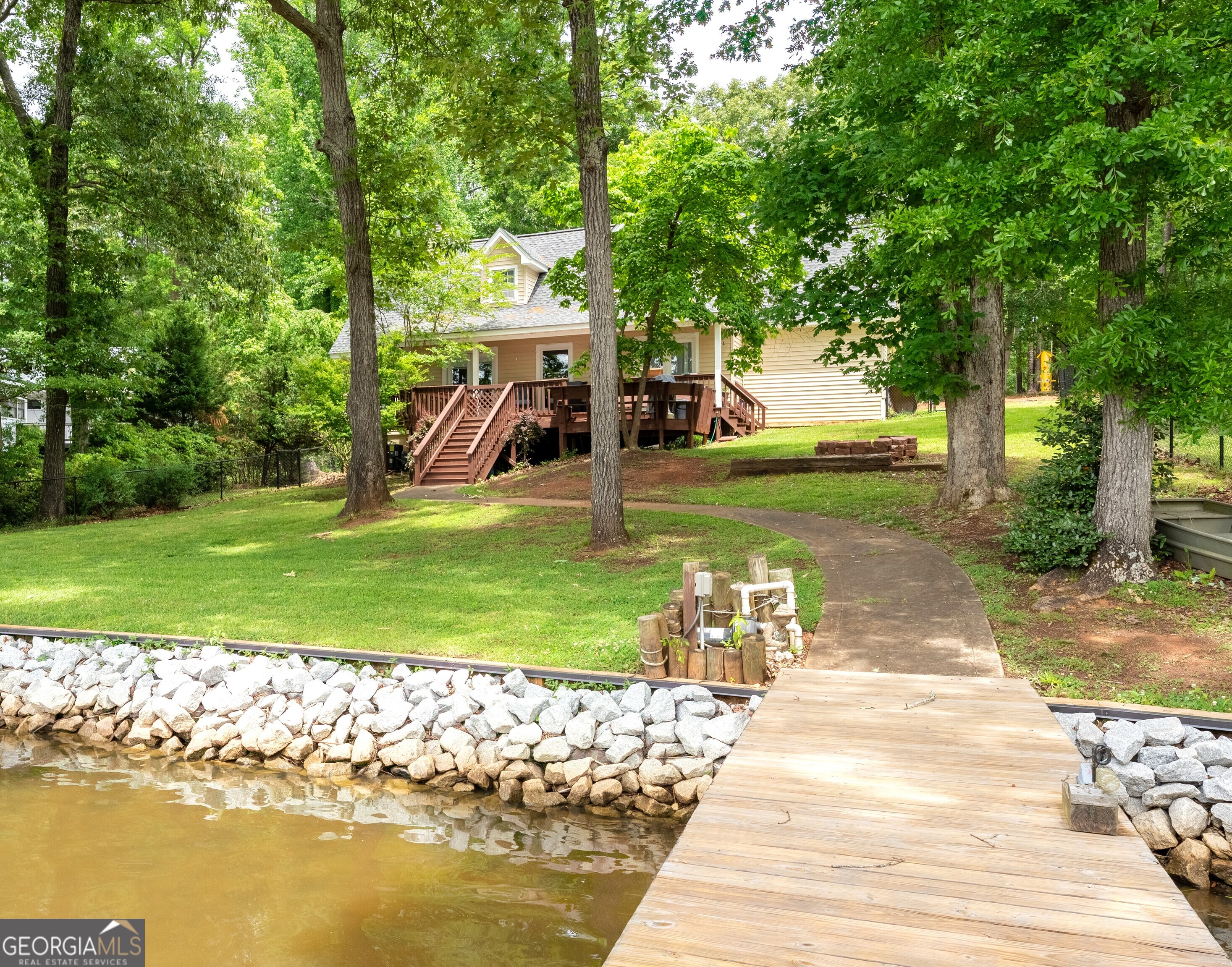 142 Tanglewood Road Southwest Eatonton, GA 31024 - Photo 3 of 50 a view of a house with garden and a patio