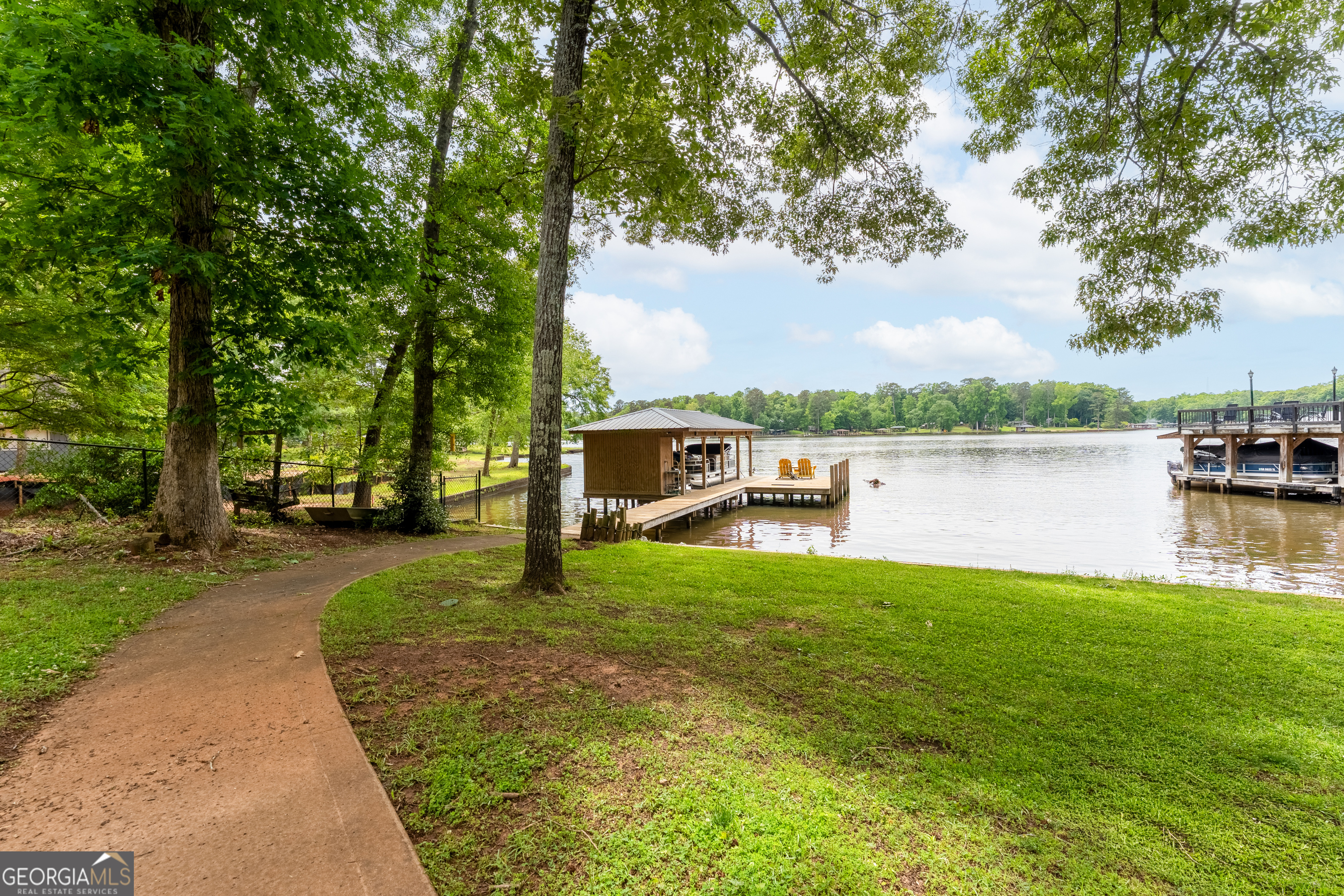 142 Tanglewood Road Southwest Eatonton, GA 31024 - Photo 33 of 50 a house with river in front of it