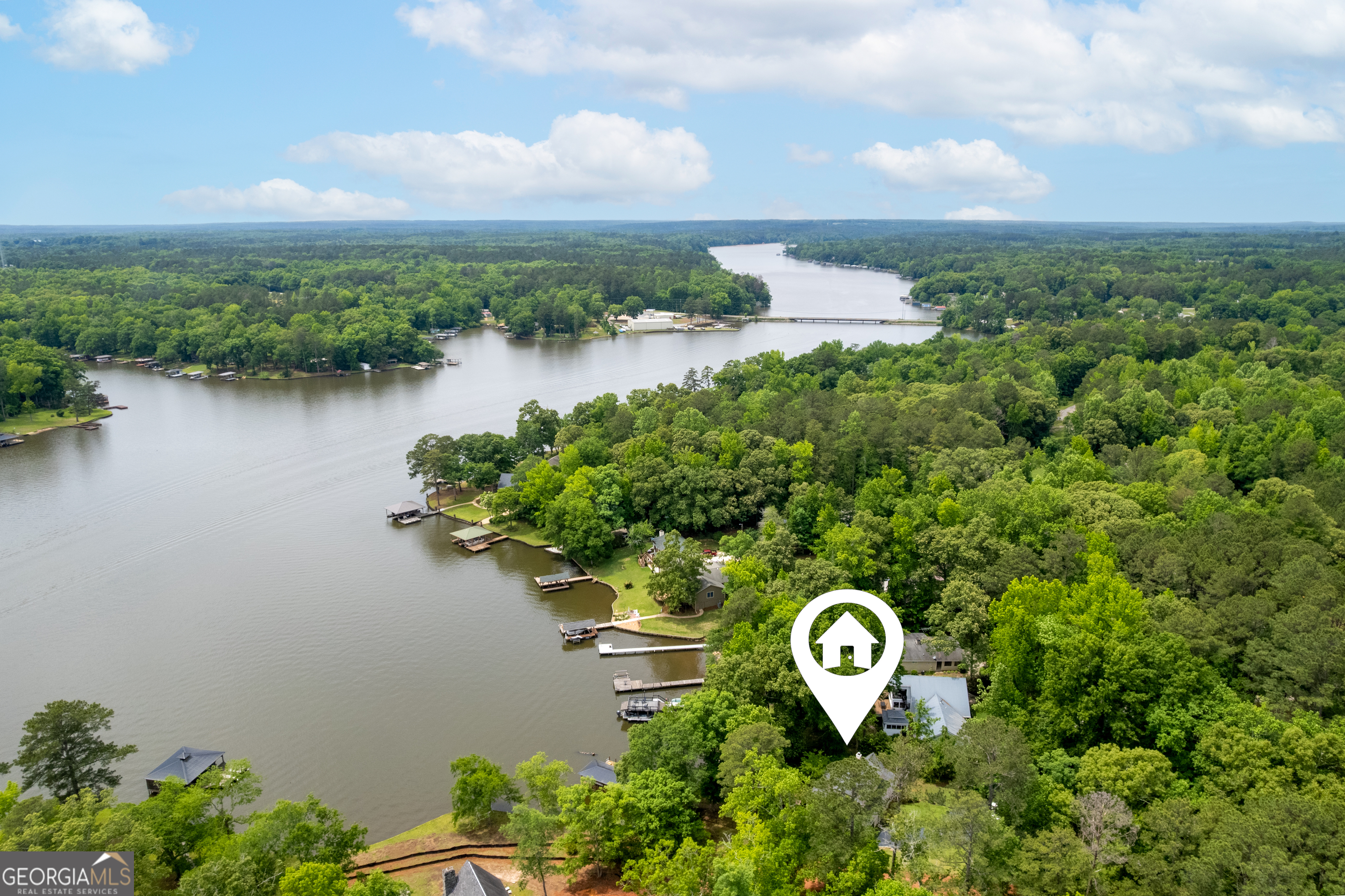 142 Tanglewood Road Southwest Eatonton, GA 31024 - Photo 50 of 50 a view of a lake with a building in the background