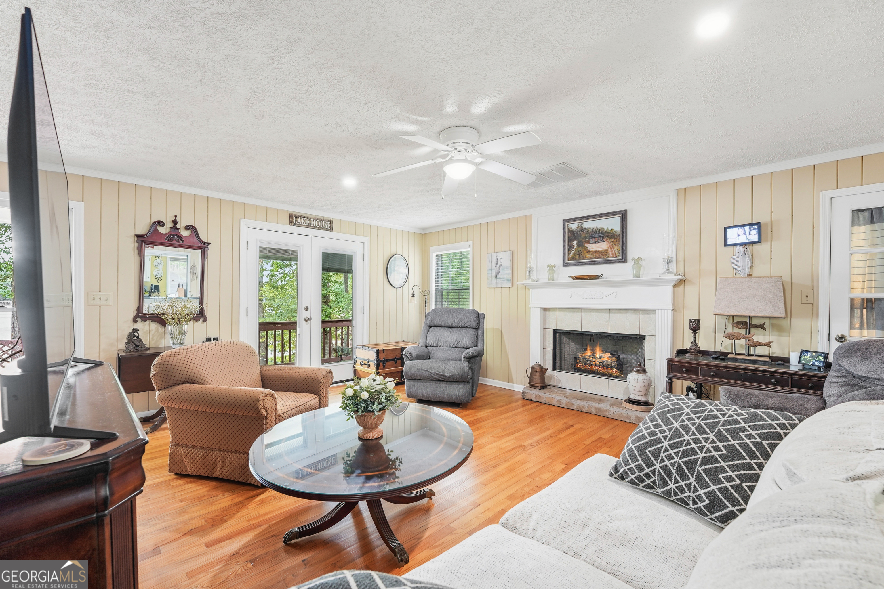 142 Tanglewood Road Southwest Eatonton, GA 31024 - Photo 7 of 50 a living room with furniture a fireplace and a table