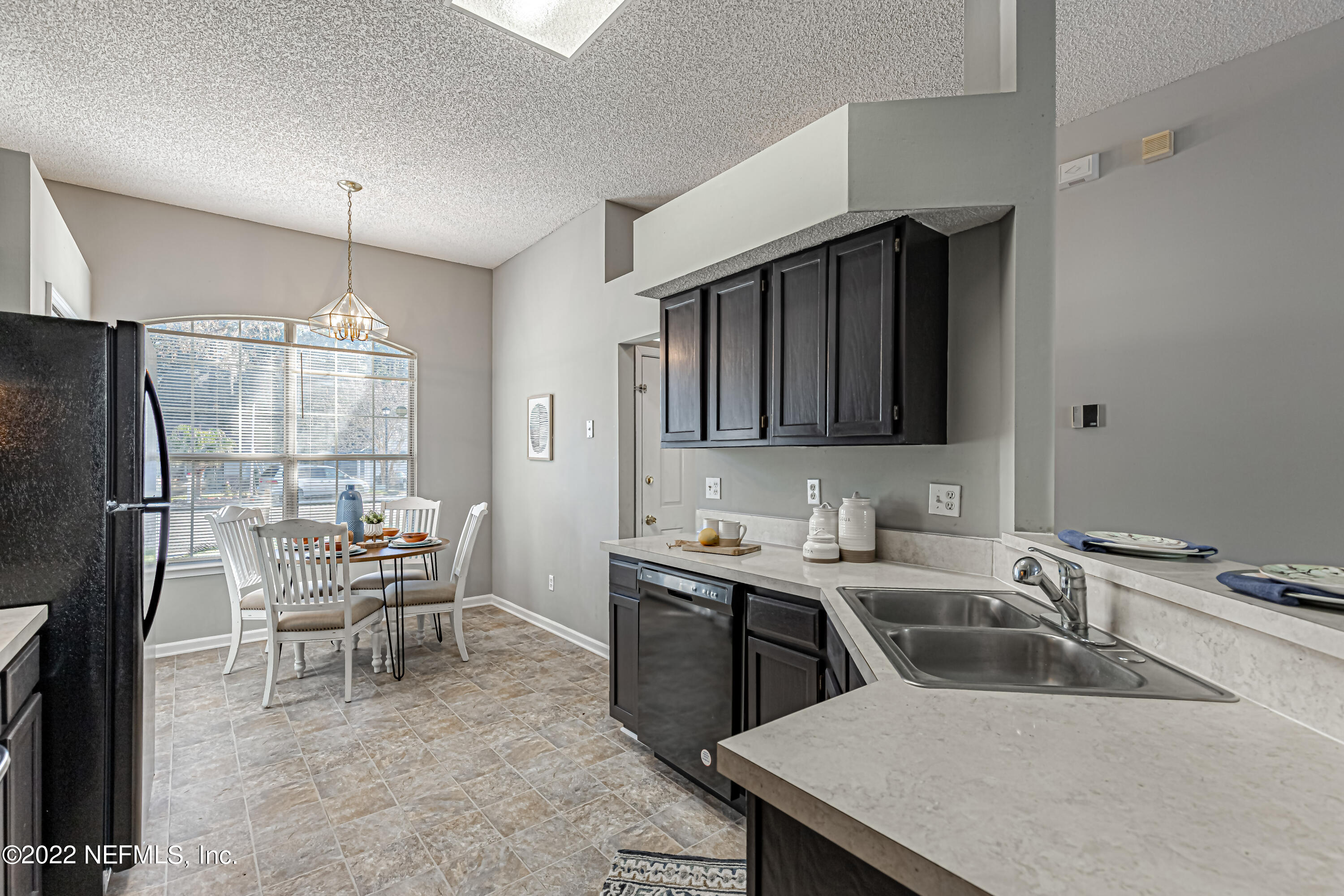 7696 Enderby Avenue East Jacksonville, FL 32244 - Photo 11 of 35 a kitchen with a sink a table and chairs