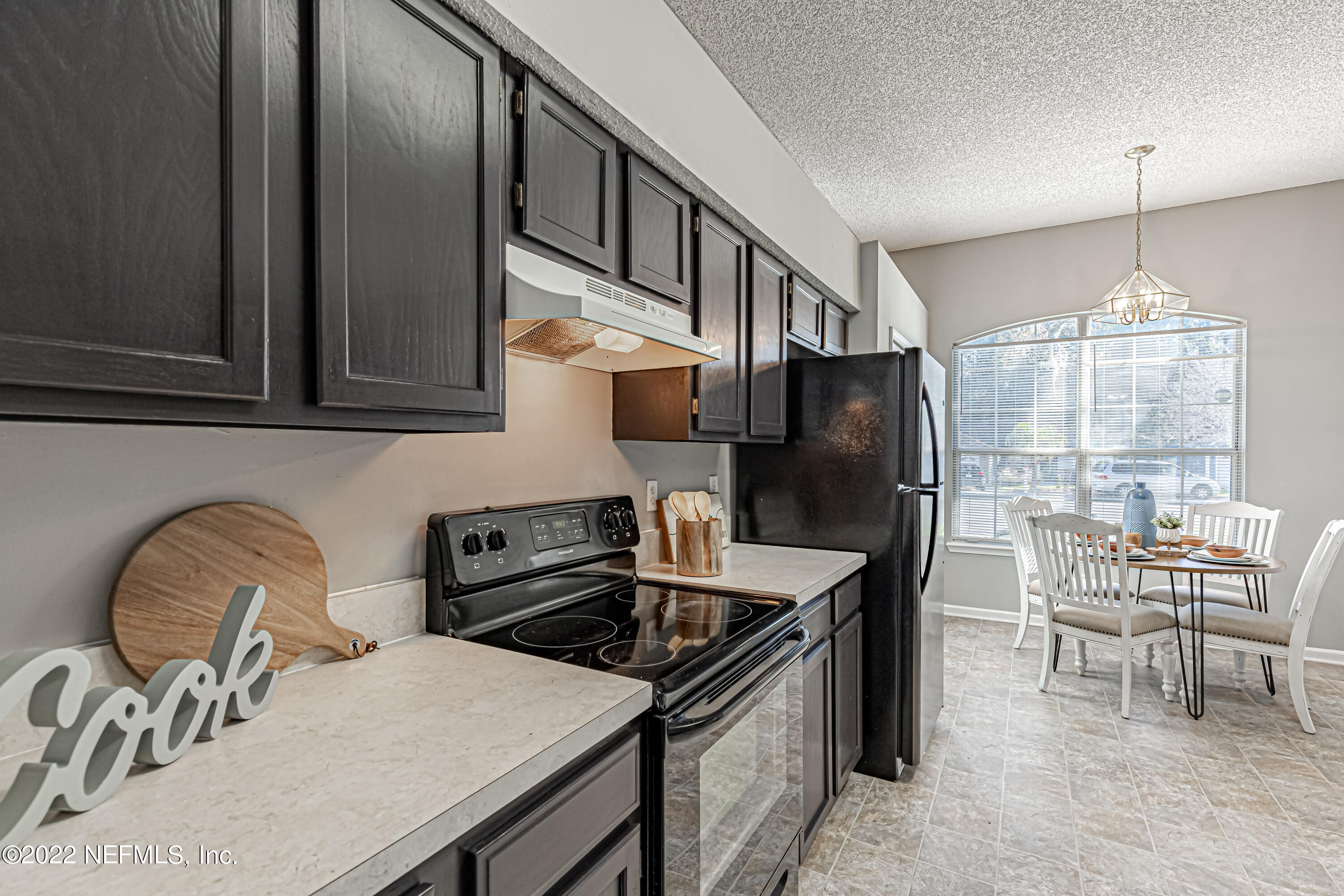 7696 Enderby Avenue East Jacksonville, FL 32244 - Photo 12 of 35 a kitchen with granite countertop a dining table and chairs