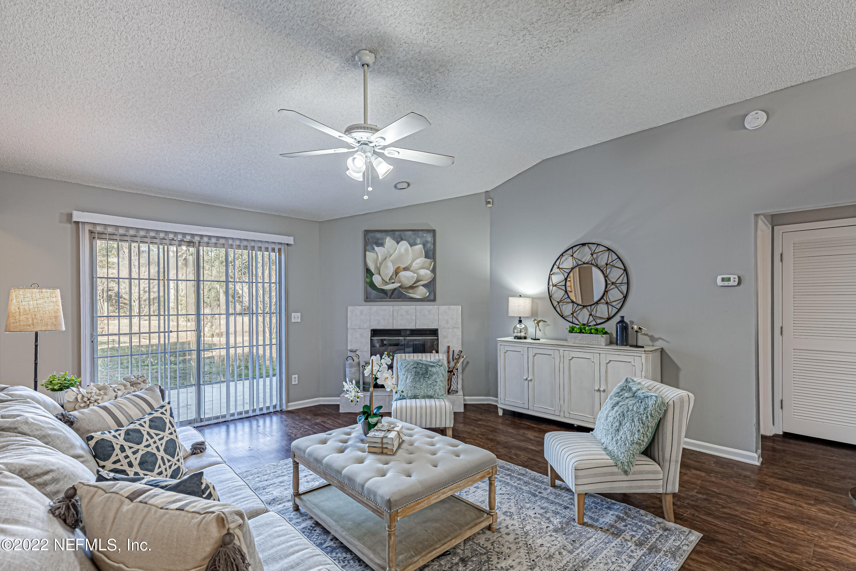 7696 Enderby Avenue East Jacksonville, FL 32244 - Photo 15 of 35 a living room with furniture a table and a large window