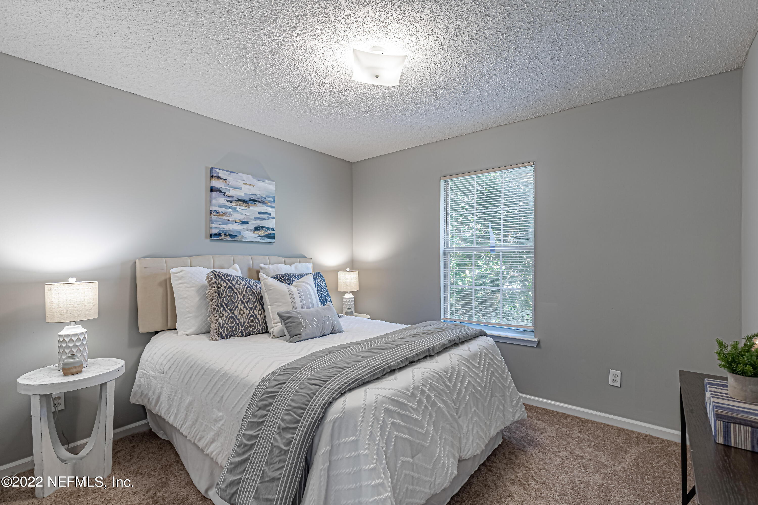 7696 Enderby Avenue East Jacksonville, FL 32244 - Photo 19 of 35 a bedroom with a large bed and a window