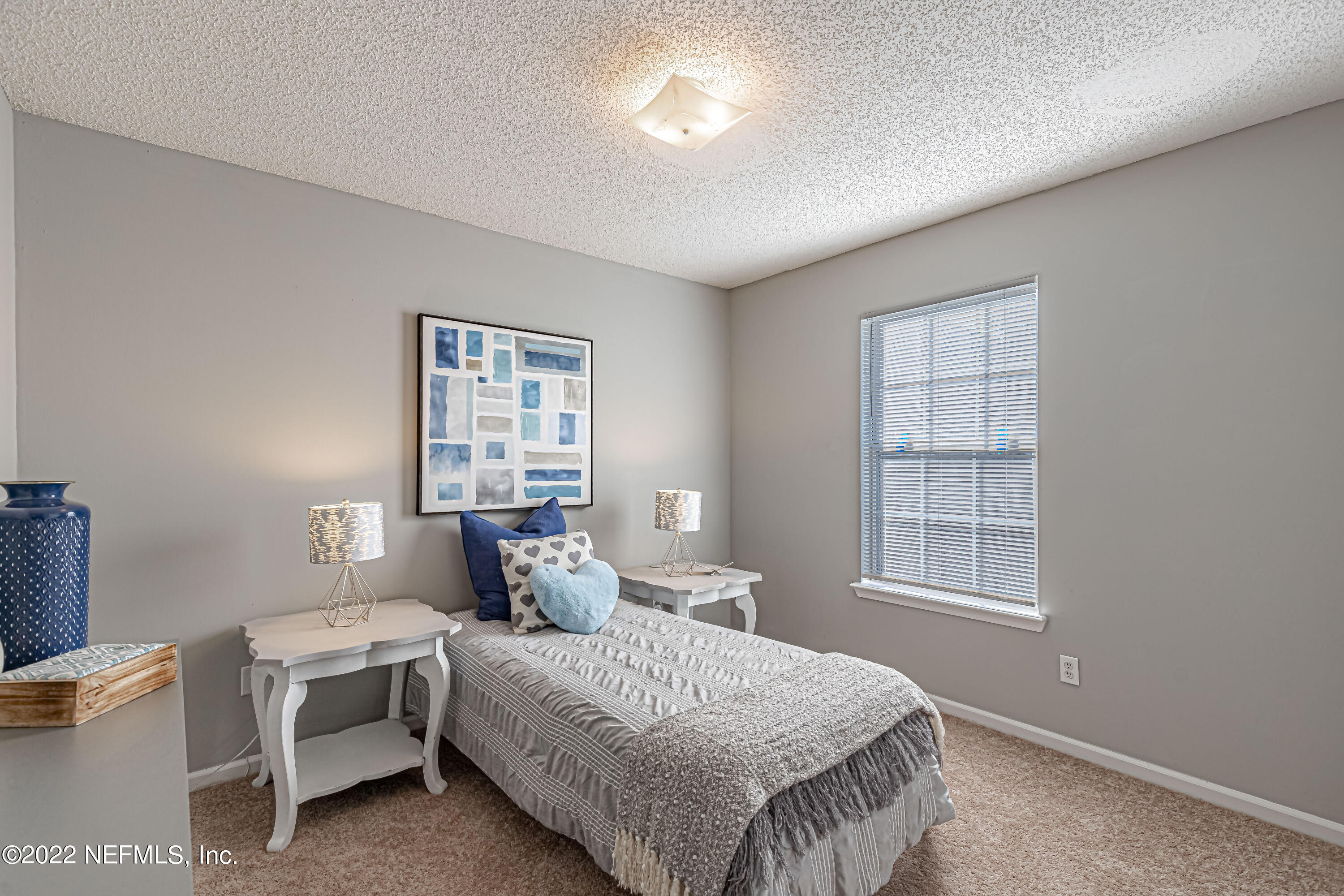 7696 Enderby Avenue East Jacksonville, FL 32244 - Photo 21 of 35 a bedroom with a large bed and a window