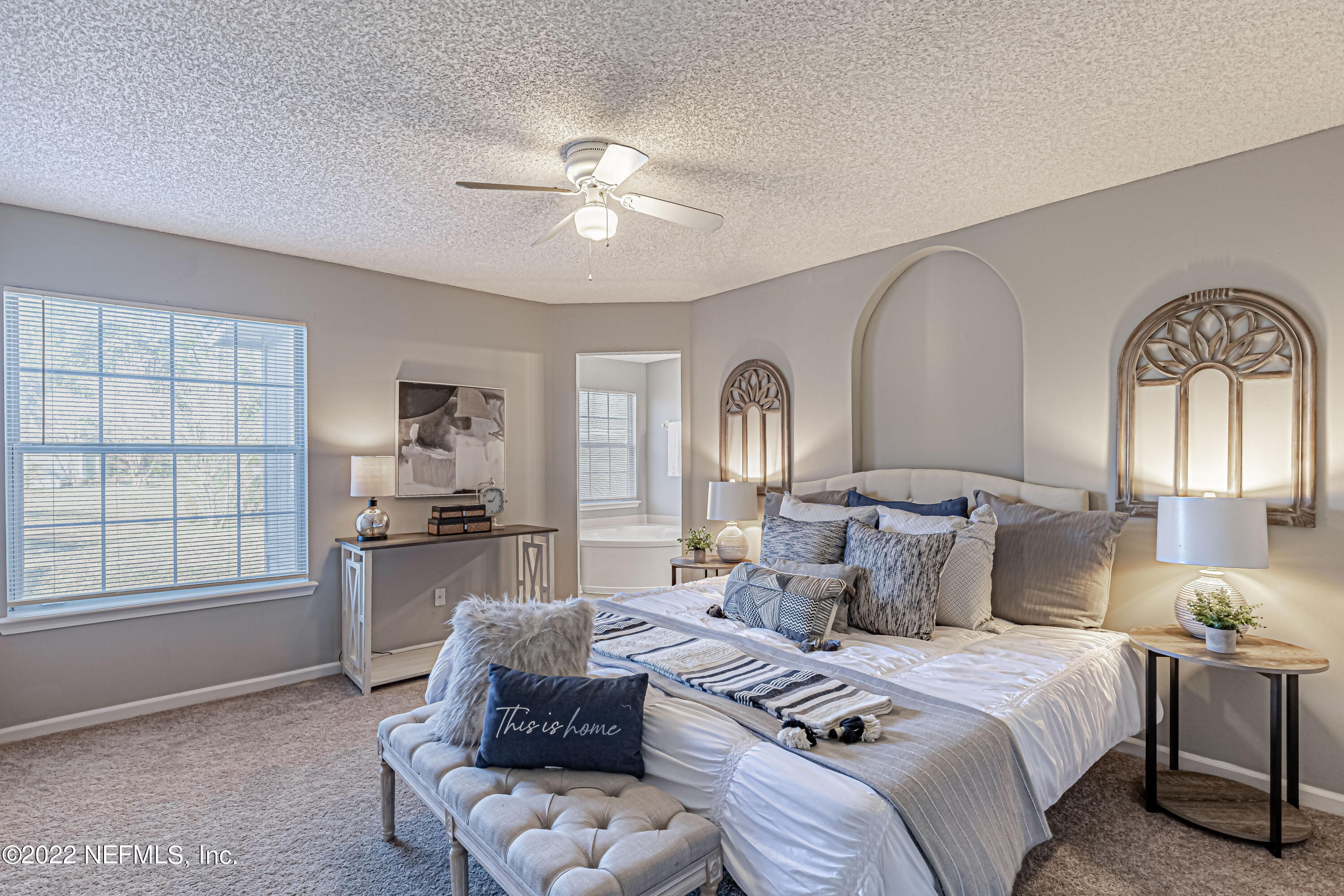 7696 Enderby Avenue East Jacksonville, FL 32244 - Photo 22 of 35 a spacious bedroom with a bed a couch and dresser