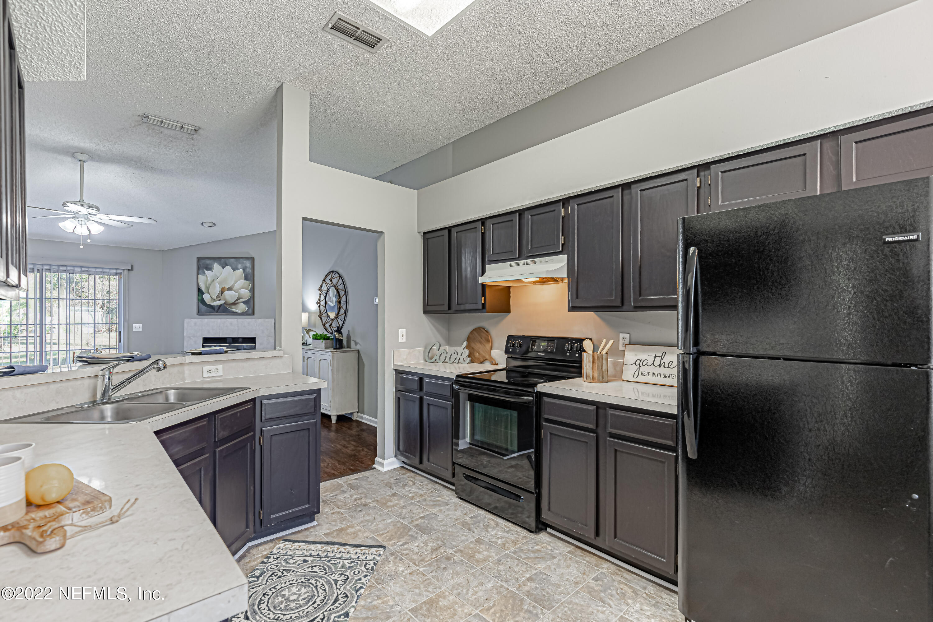 7696 Enderby Avenue East Jacksonville, FL 32244 - Photo 10 of 35 a kitchen with stainless steel appliances granite countertop a sink stove and refrigerator