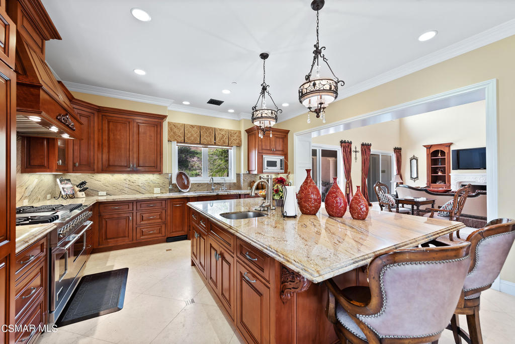 2462 Lost Canyons Drive Simi Valley, CA 93065 - Photo 12 of 50 a open kitchen with stainless steel appliances granite countertop a kitchen island a stove a table and chairs