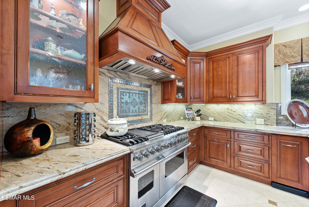 2462 Lost Canyons Drive Simi Valley, CA 93065 - Photo 13 of 50 a kitchen with stainless steel appliances granite countertop a stove and a sink