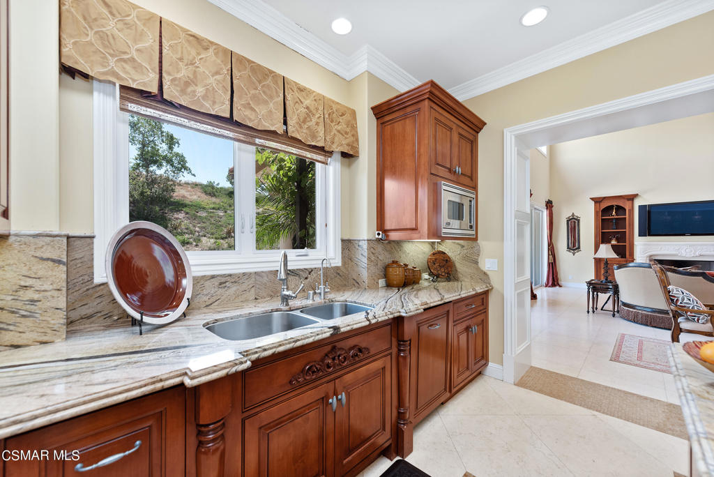 2462 Lost Canyons Drive Simi Valley, CA 93065 - Photo 14 of 50 a kitchen with a sink stove and a refrigerator
