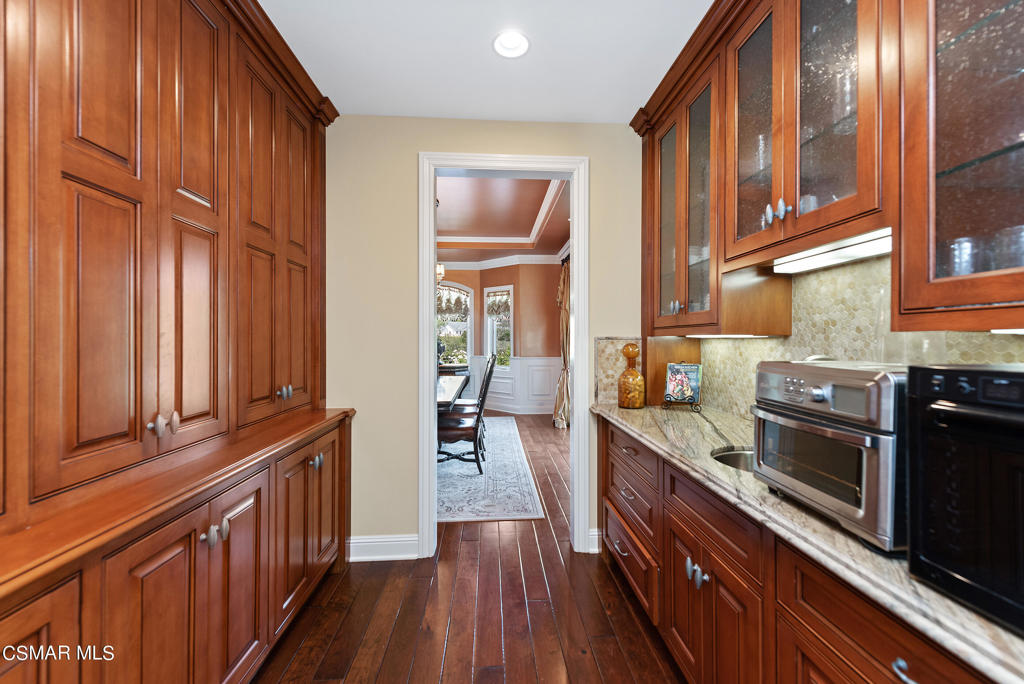 2462 Lost Canyons Drive Simi Valley, CA 93065 - Photo 17 of 50 a kitchen with stainless steel appliances granite countertop a refrigerator a stove and a wooden cabinets