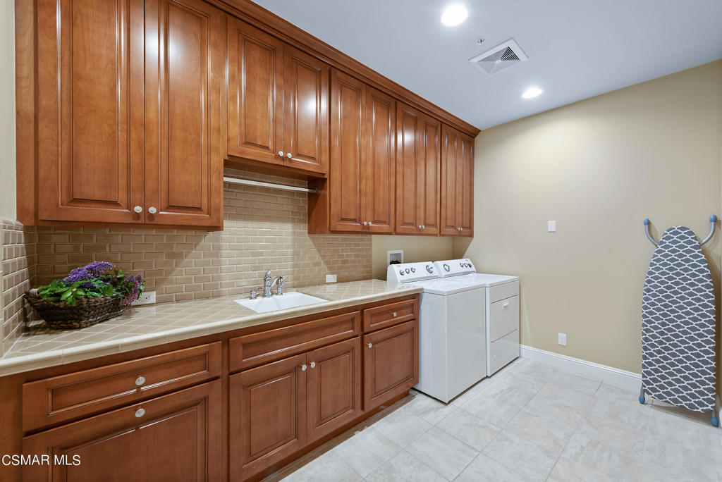2462 Lost Canyons Drive Simi Valley, CA 93065 - Photo 23 of 50 a kitchen with a sink and cabinets