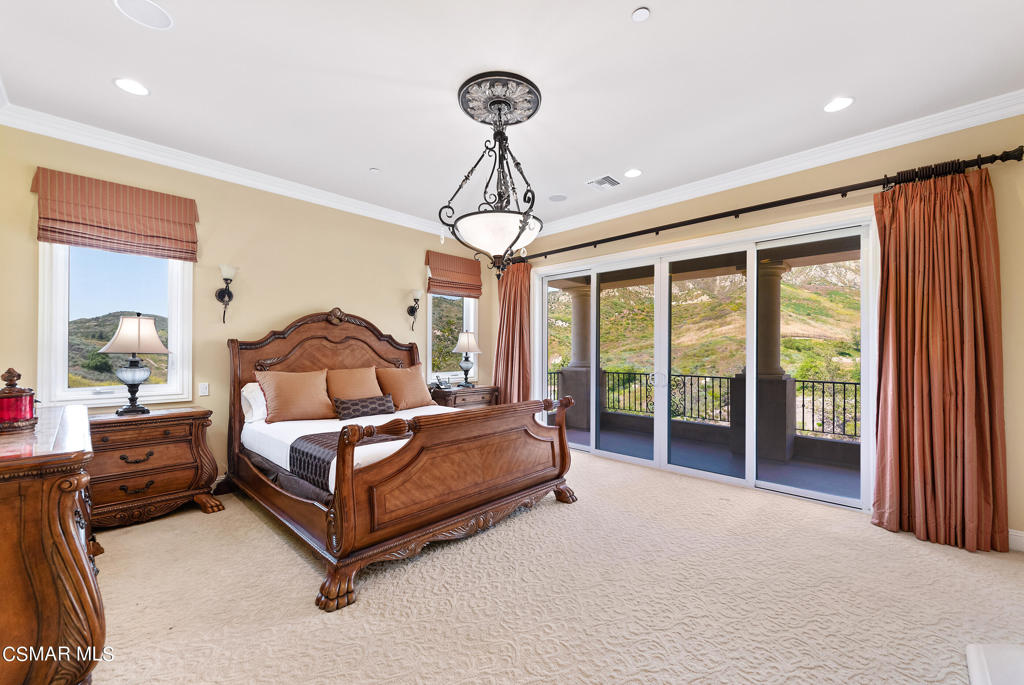 2462 Lost Canyons Drive Simi Valley, CA 93065 - Photo 33 of 50 a bedroom with a bed and a chandelier
