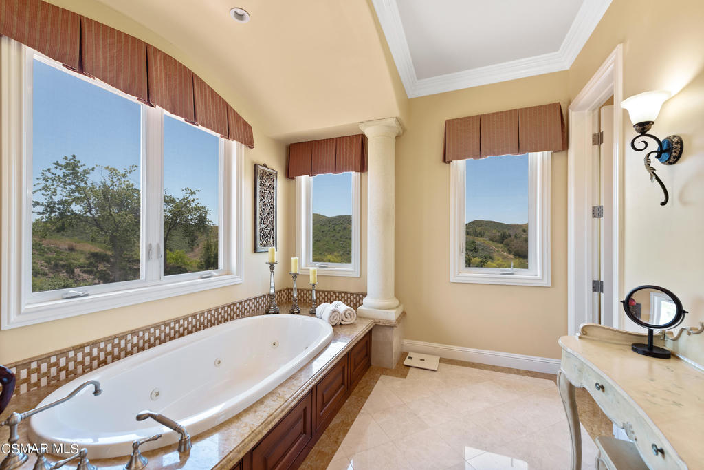 2462 Lost Canyons Drive Simi Valley, CA 93065 - Photo 38 of 50 a bathroom with a tub a sink and a window