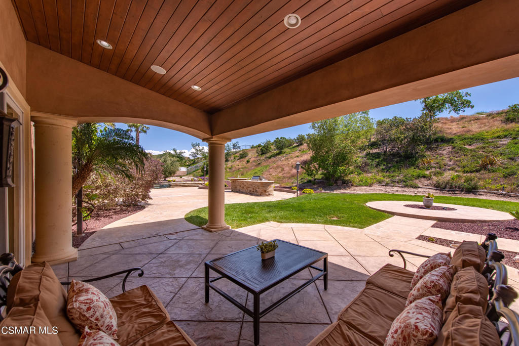 2462 Lost Canyons Drive Simi Valley, CA 93065 - Photo 39 of 50 a view of a patio with a table chairs and a backyard