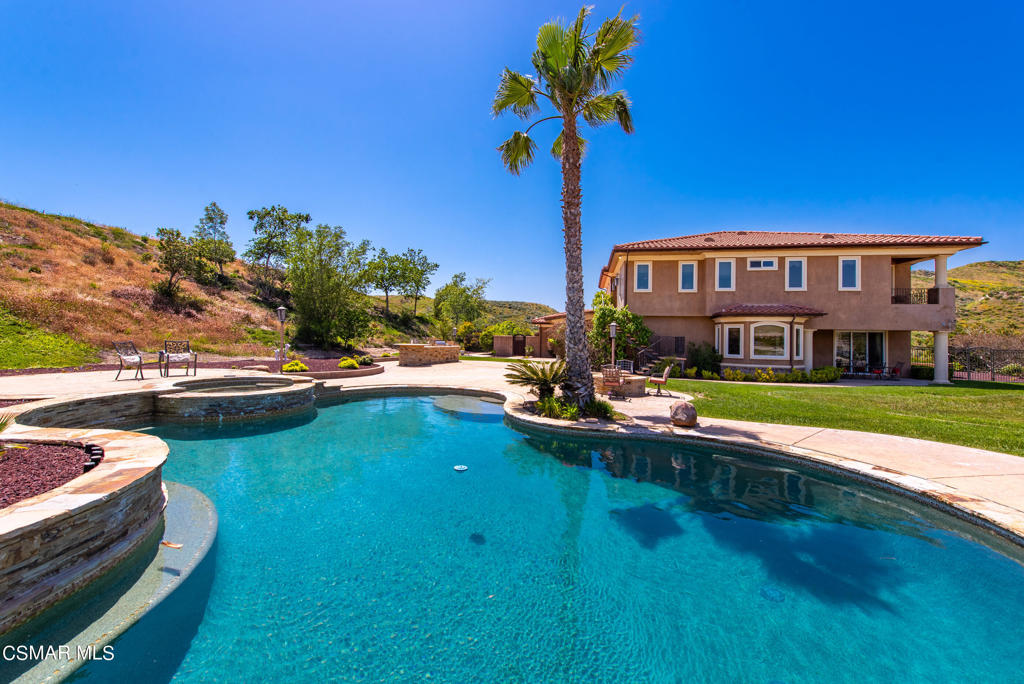 2462 Lost Canyons Drive Simi Valley, CA 93065 - Photo 42 of 50 a front view of a house with swimming pool having outdoor seating