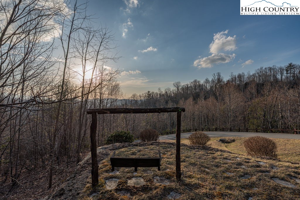 105 B Beaver Dam Road Elk Park, NC 28622 - Photo 26 of 31 a backyard of a house with table and chairs