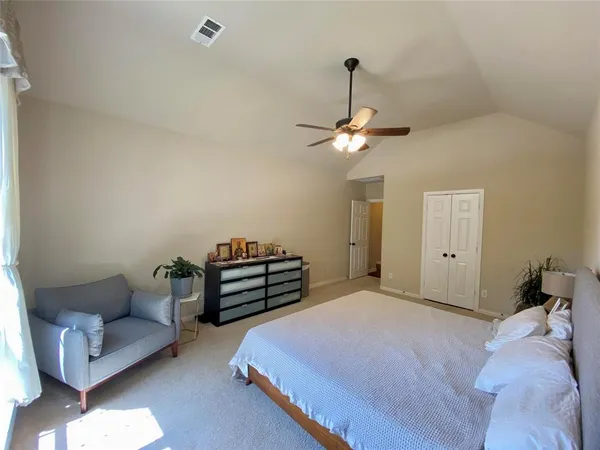 a bedroom with a bed and chandelier