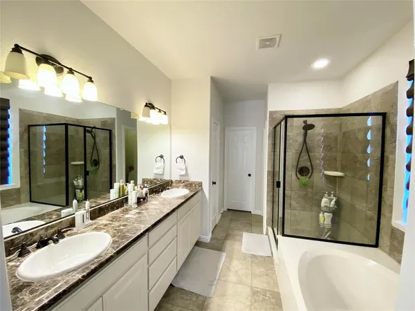 a bathroom with a granite countertop sink mirror and shower