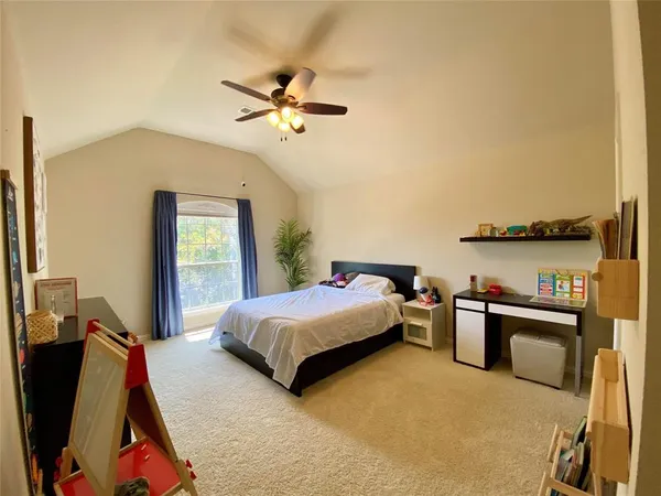 a living room with a bed furniture and a window