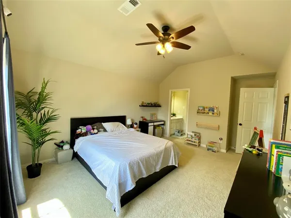 a bedroom with a bed and ceiling fan