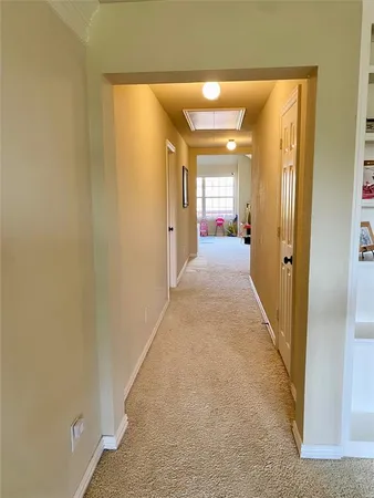 a view of a hallway with wooden shelves