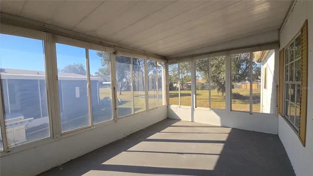 a living room with furniture and floor to ceiling windows