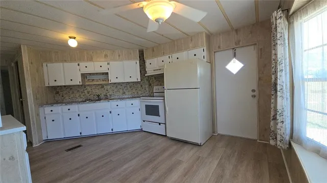 a kitchen with stainless steel appliances a refrigerator sink and cabinets