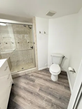 a bathroom with a toilet and a shower