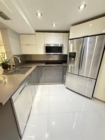 a kitchen with stainless steel appliances a refrigerator a sink and a stove