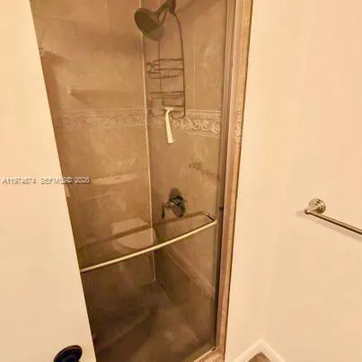 a bathroom with a glass shower door