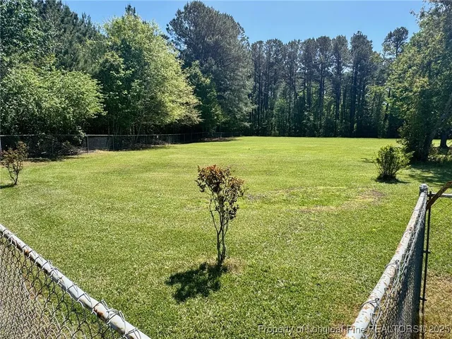 a view of a swimming pool and a yard
