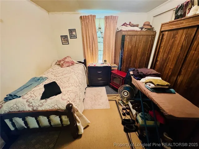 a bedroom with a bed and a dresser