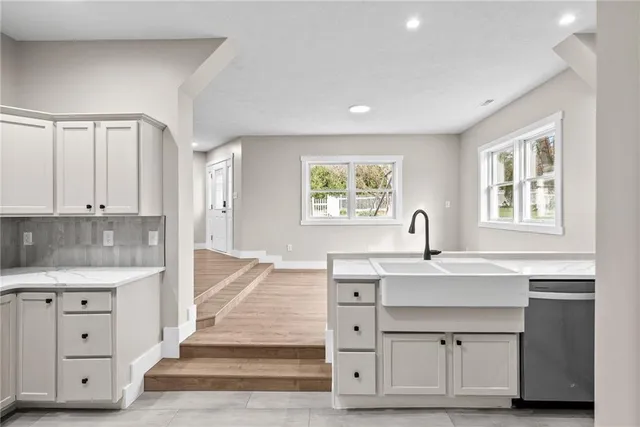 a spacious bathroom with a granite countertop sink and a mirror