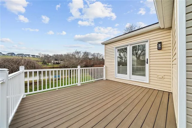 a view of a wooden deck with a yard