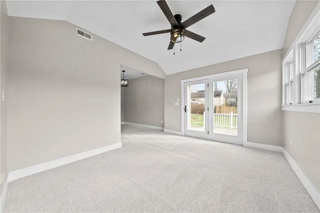 a view of a livingroom with a ceiling fan and window