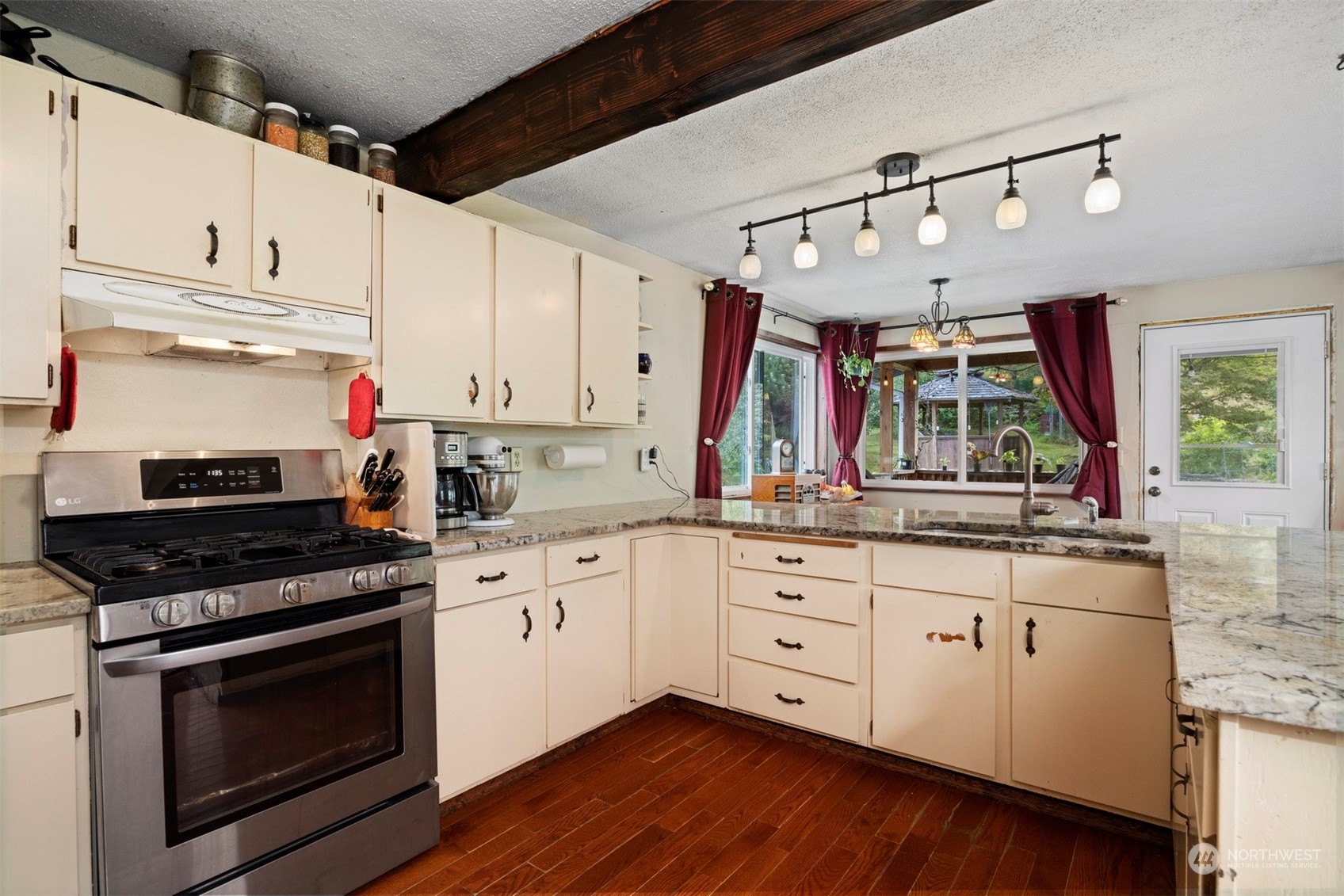 3810 Nelson Road Deming, WA 98244 - Photo 8 of 40 a kitchen with granite countertop white cabinets and appliances