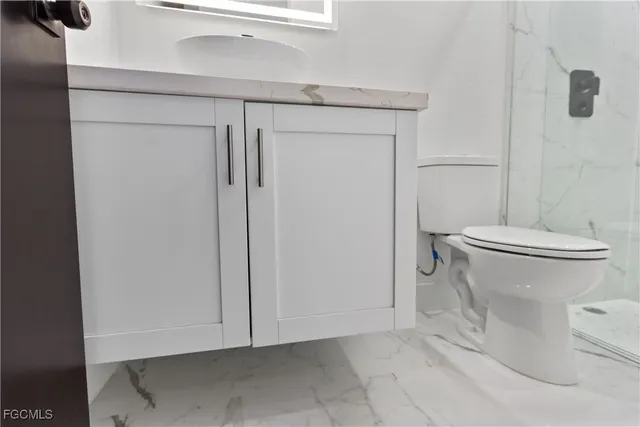 a large kitchen with cabinets and stainless steel appliances