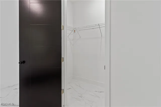 a view of an white house with a yard