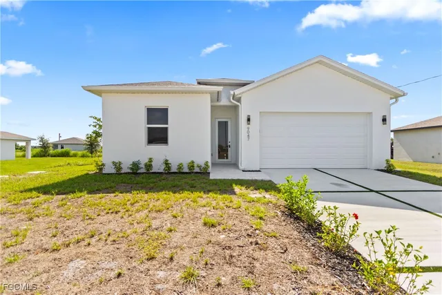 a view of a house with a backyard