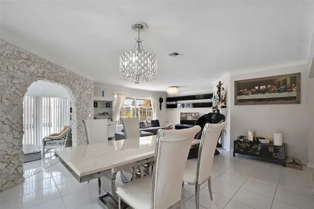 a kitchen with a table chairs refrigerator and microwave