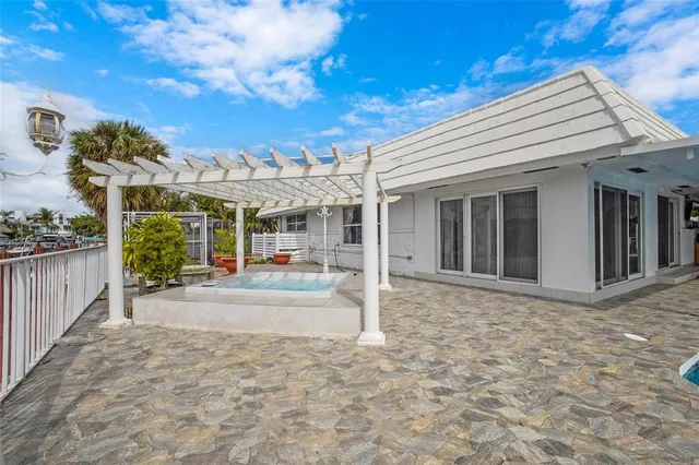 a view of a house with patio and potted plants