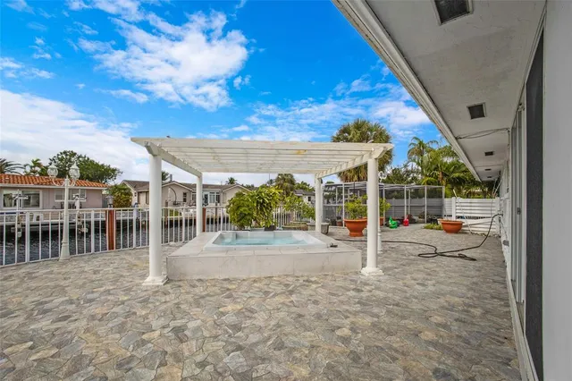 a view of swimming pool with outdoor seating and plants