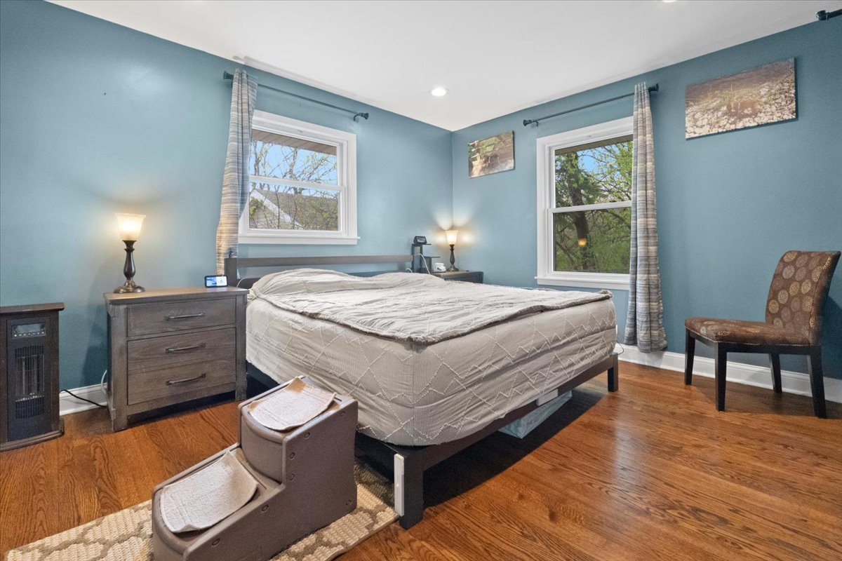 2517 Salem Boulevard Zion, IL 60099 - Photo 14 of 32 a bedroom with a bed and a chair